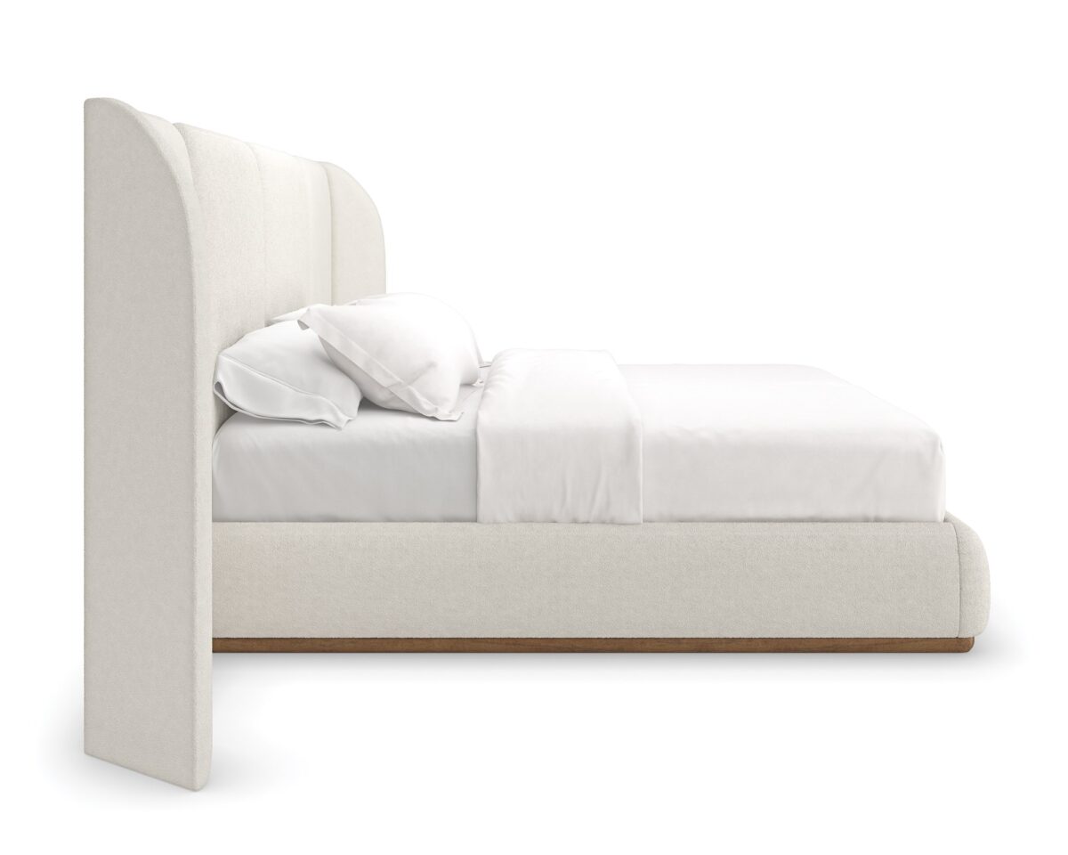Caracole Malta Upholstered King Bed featuring a fully upholstered frame in deep-pile microfiber, complemented by a Toasted Pecan wood base, with softly rounded edges and a soothing symmetrical design.