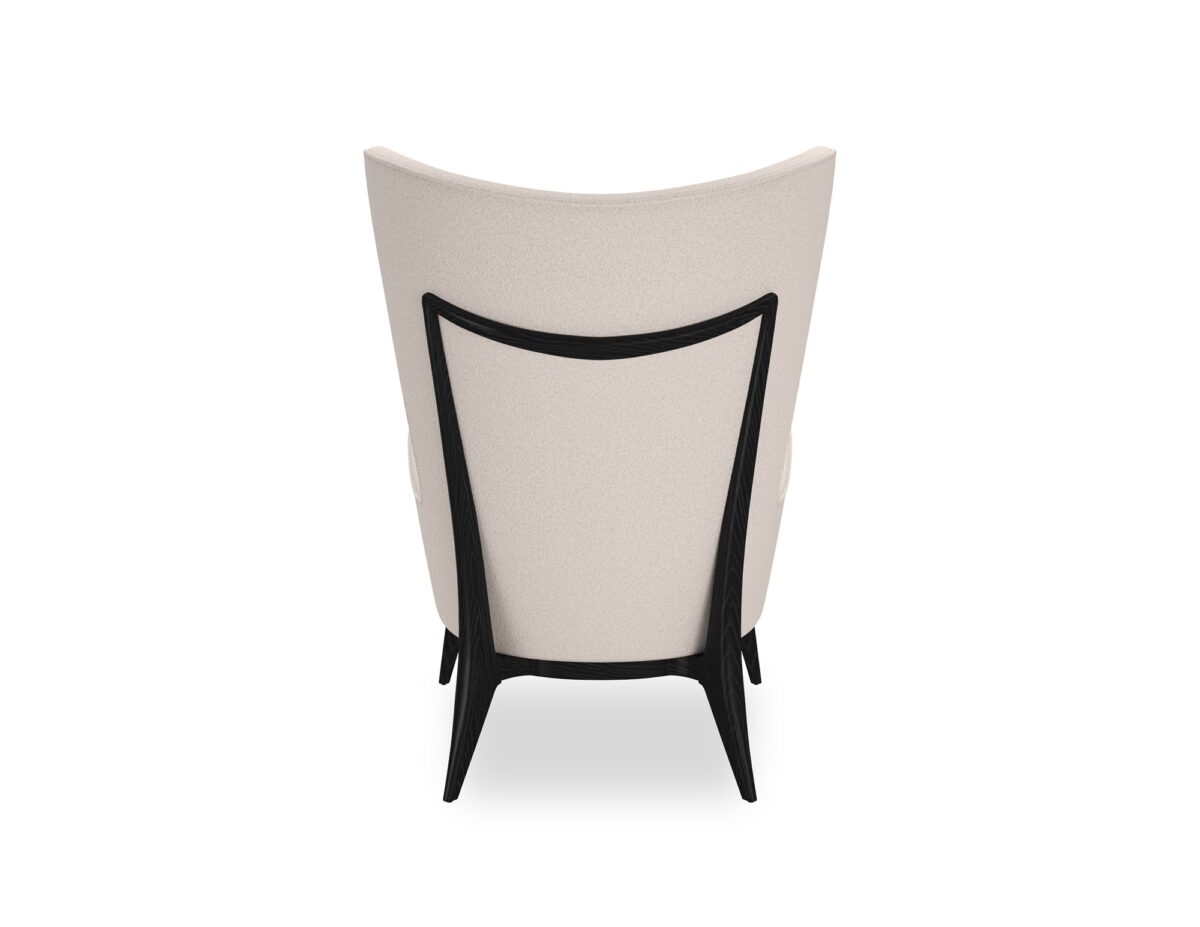 The Caracole "Whats New Pussycat?" wing chair, featuring a modern Scandinavian design with a light-colored upholstered body, gracefully sloped arms, a soft round back, and a distinctive exposed wood detail on the outback in a Modern Walnut or Almost Black finish.