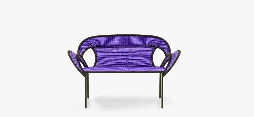 Colorful woven Banjooli chair with curved backrest and angled metal legs, designed by Moroso.