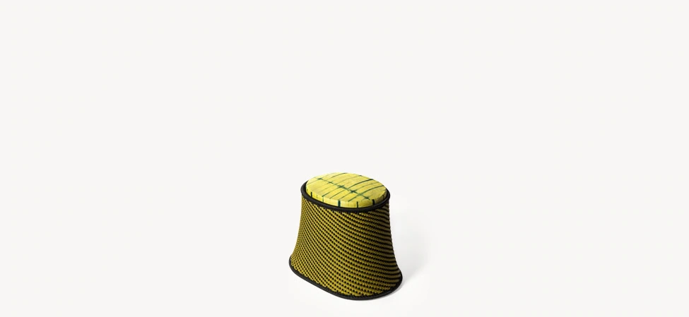 Baobab pouf with yellow-and-black diagonally woven polyethylene threads over a painted steel base, topped with a colorful African-print cushion