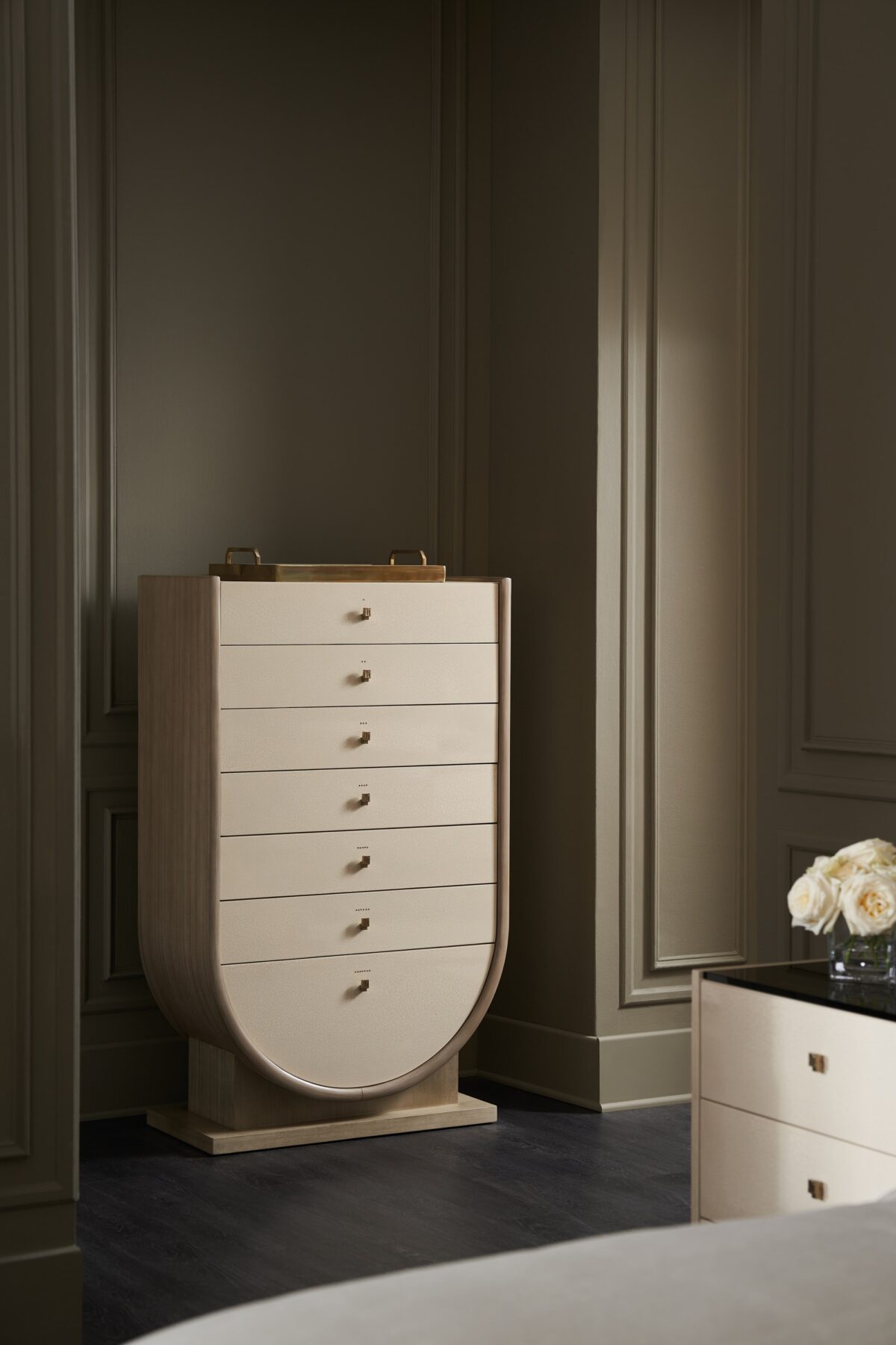 Elegant tall chest of drawers with a sculptural, Grecian-inspired form and textured finish, AMPHORA by Caracole.