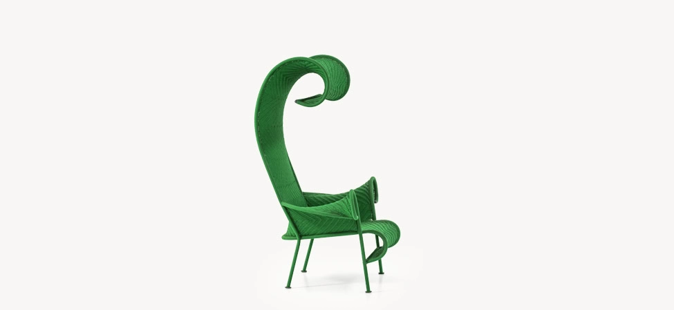 Shadowy by Moroso armchair in deep charcoal fabric with rounded edges and slender metal legs