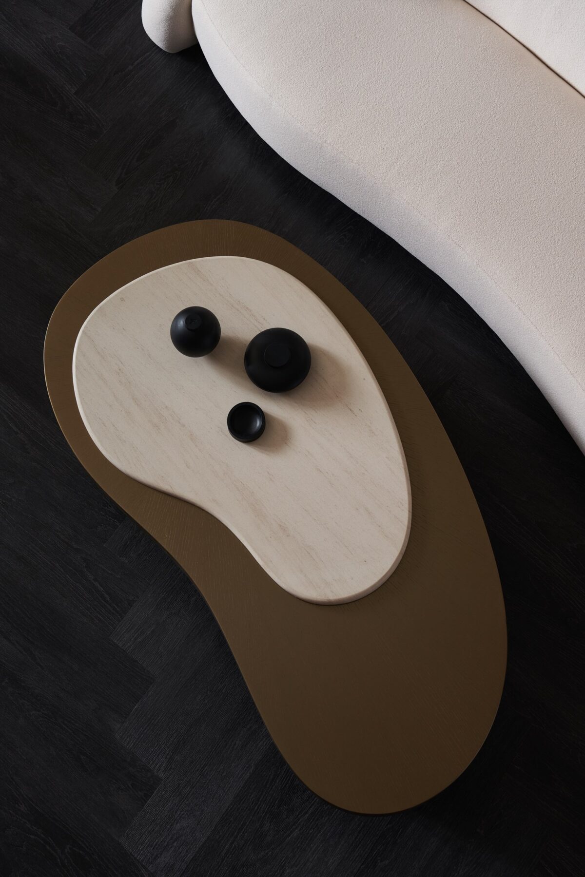 Modern cocktail table featuring contrasting light and dark veneers for a striking visual effect.