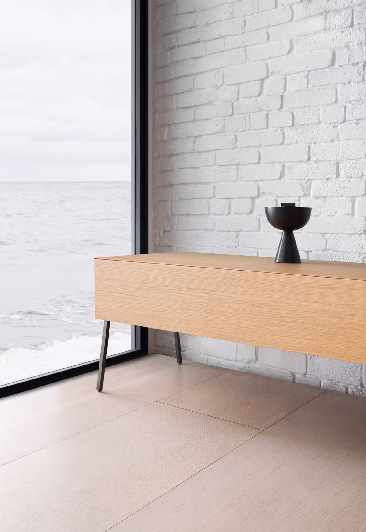 Modern interior featuring Into by Bensen chair in charcoal upholstery paired with a minimalist side table