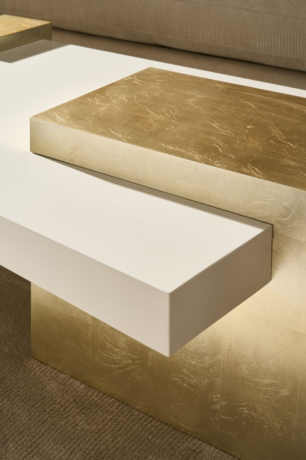 Contemporary cocktail table featuring a clear glass surface that appears to hover above a slim metal frame.
