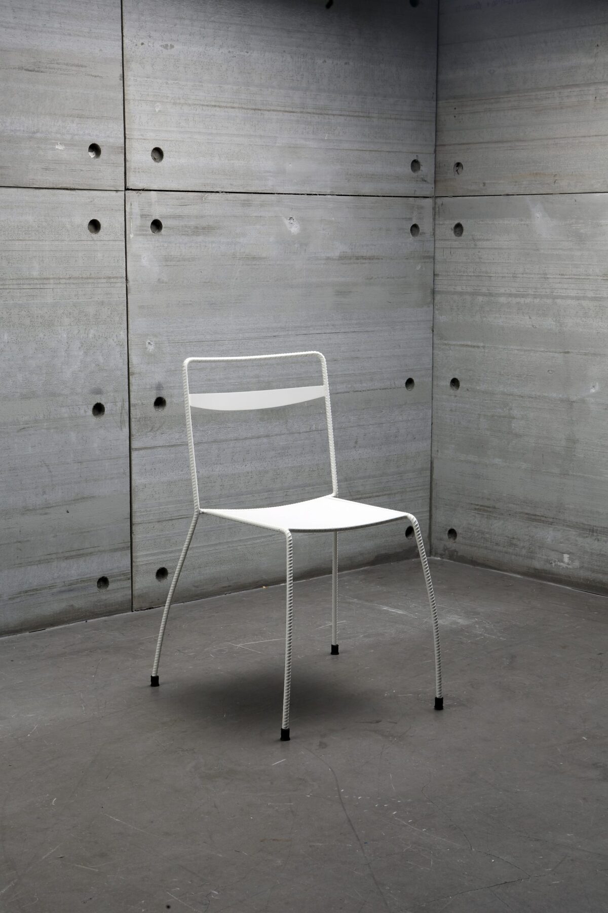 Close-up of Tondella Chair's backrest, highlighting the subtle ribbed texture and craftsmanship of the steel frame.