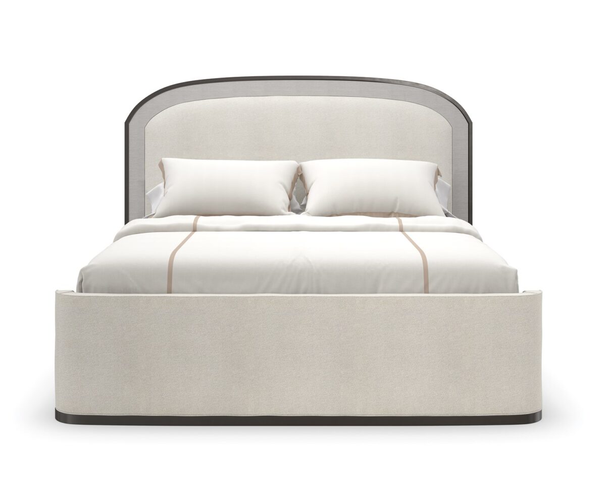 A WANDERLUST King Bed by Caracole in a well-appointed bedroom, demonstrating its ability to anchor the space with its grand proportions and luxurious details.