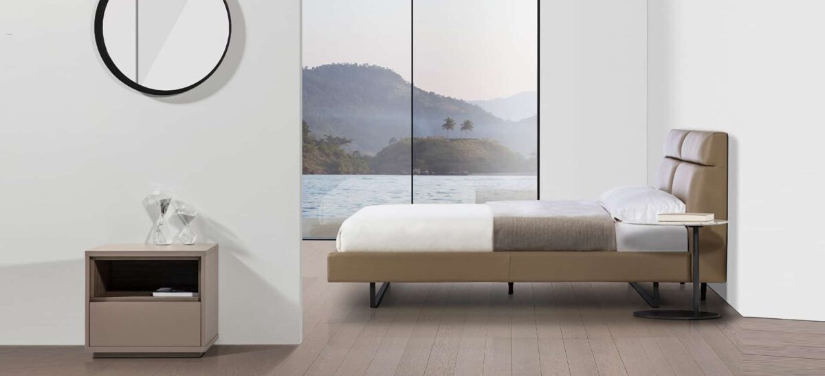 Contemporary upholstered bed with plush headboard and sleek frame by Camerichusa.