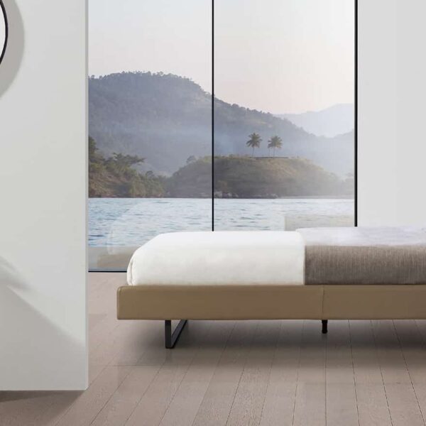 Contemporary upholstered bed with plush headboard and sleek frame by Camerichusa.