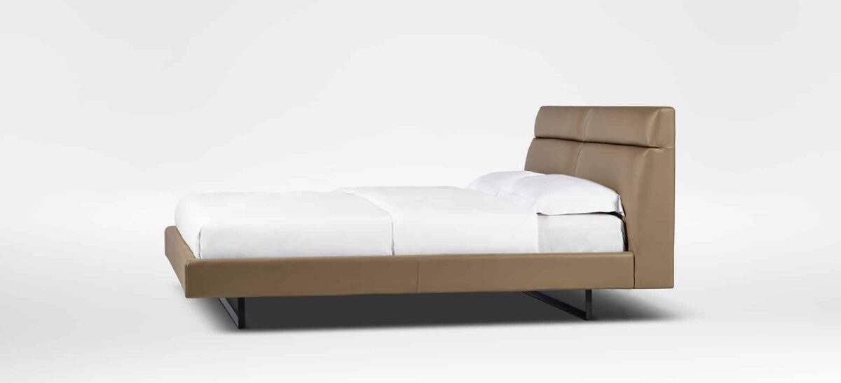 Contemporary upholstered bed with plush headboard and sleek frame by Camerichusa.