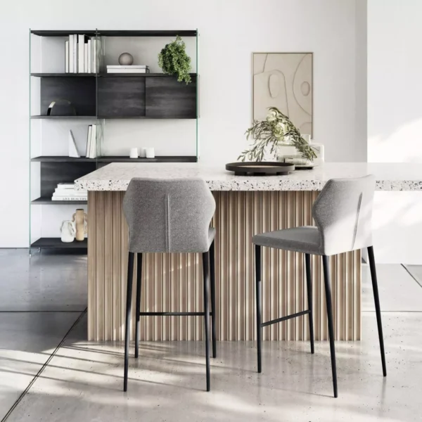 Angle kitchen counter by Peressini with L-shaped wooden countertop and slender metal supports in a minimalist kitchen.