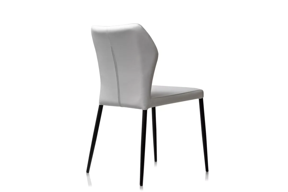 Side view of Angle by Peressini highlighting its sculptural frame, ergonomic angle, and slender legs.