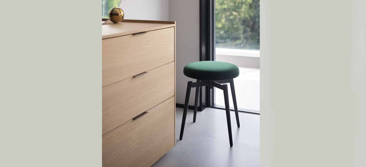 Modern upholstered swivel chair with clean lines and sleek legs by Camerich.