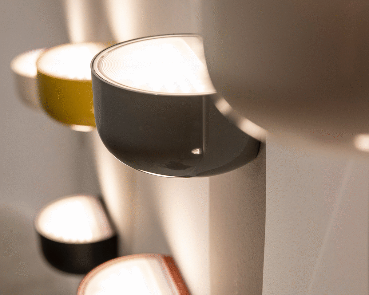 Modern and discreet, the Flos Bellhop Wall Up light fixture, showcasing its simple yet refined design in [specific finish, e.g., "white" or "cioko"], perfect for ambient or task lighting in various indoor spaces.