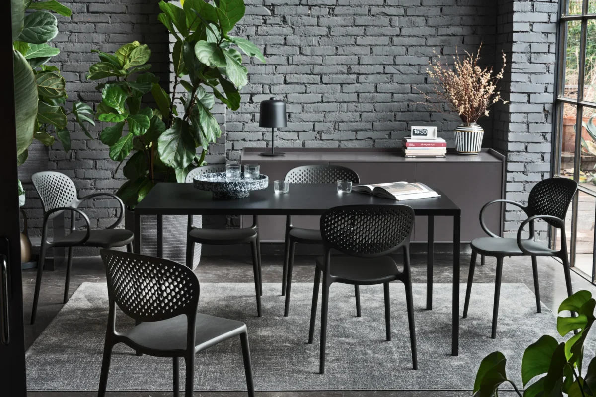 “Side view of IRON table by Connubia – modern dining table with exposed steel structure and clean-lined tabletop for contemporary interiors”