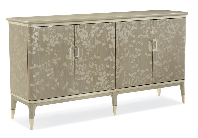 Turn A New Leaf by Caracole — an elegant console table with a leaf-motif metal base and glass top.