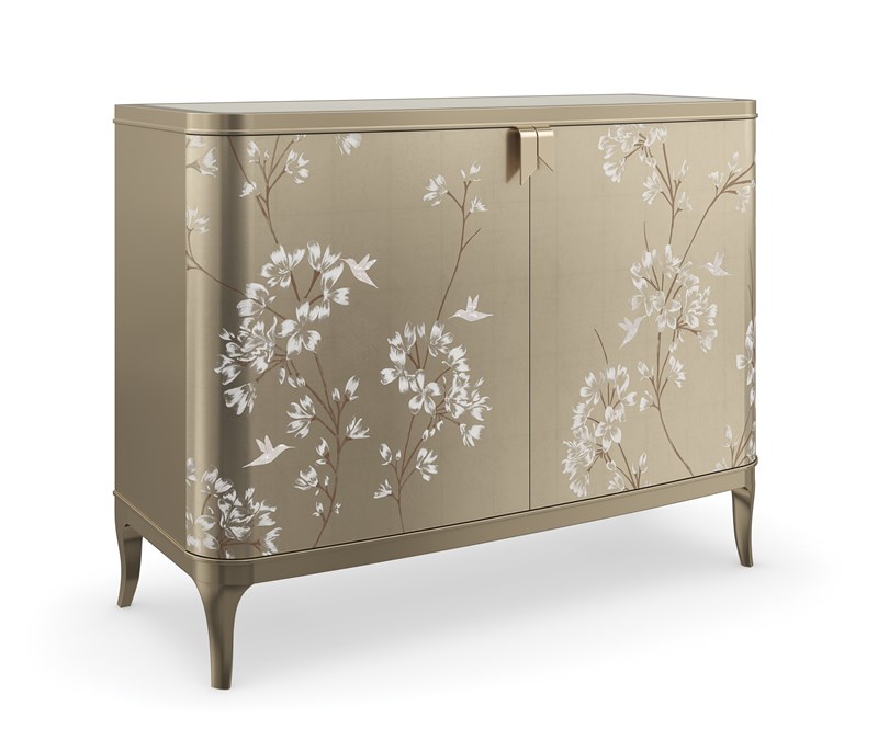 Eden by Caracole — a luxurious bed with an arched, upholstered headboard and metallic trim.
