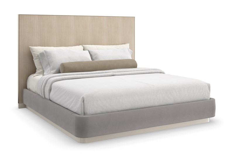 Caracole Dream Chaser King Bed featuring a parsons-shaped headboard crafted from Koto veneers finished in Dry Martini, encased in Brushed Gold metal trim, with wood-paneled wings, upholstered side rails and footboard in pale gray mohair fabric, set on a Cloud-finished wood plinth base.