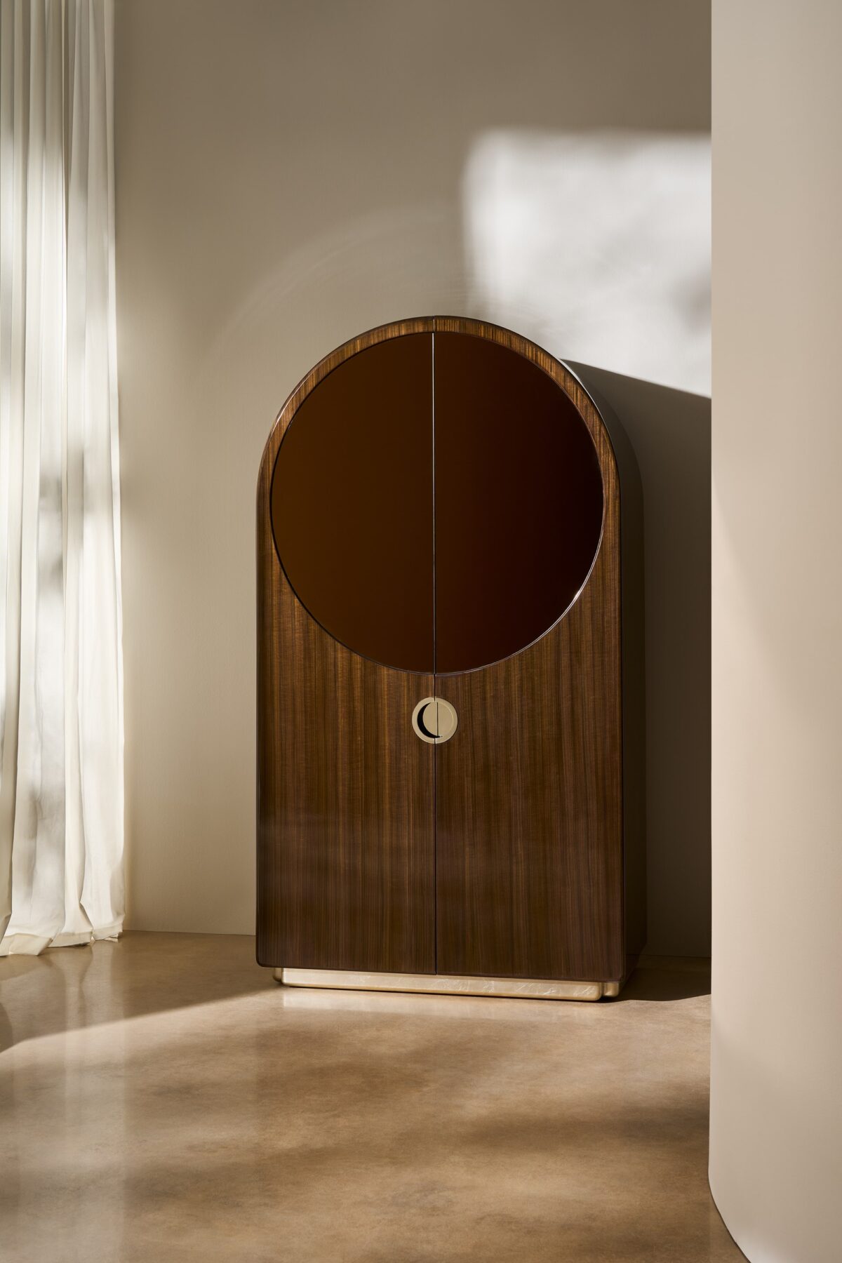 Modern GELEE Armoire by Caracole, showcasing its clean lines, minimalist silhouette, and a vibrant, lacquered exterior, ideal for adding a warm color statement to a room.