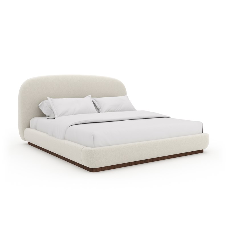 Caracole Botero King Bed featuring an oversized, ultra-plush, fully-upholstered headboard in Ivory mélange performance bouclé fabric, with padded side rails and footboard, set on a Retro Walnut plinth base.