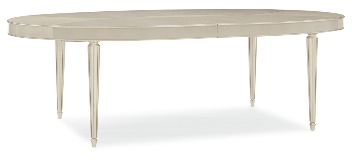 The Source dining table by Caracole with a stunning Smoked Birdseye and Thunder wood top, featuring soft silver paint accents and brushed chrome ferrules.