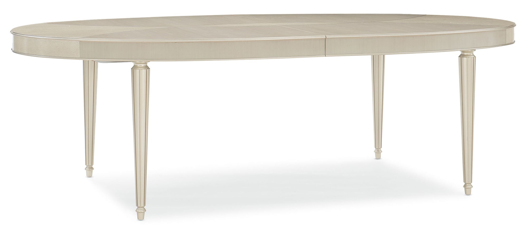 The Source dining table by Caracole with a stunning Smoked Birdseye and Thunder wood top, featuring soft silver paint accents and brushed chrome ferrules.