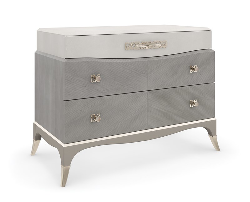 Vibrato sideboard by Caracole featuring a rippled front design and metallic accents.
