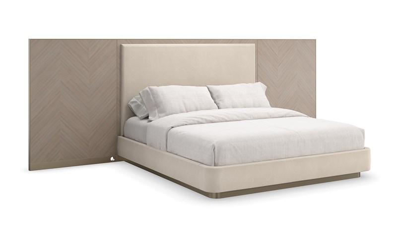 Luxurious Caracole Anthology King Bed with Chevron-patterned Koto veneer wings and a soft wool-like flannel upholstered headboard, finished with Brushed Gold metal accents.