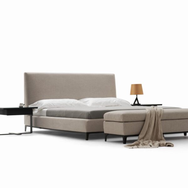 Elegant upholstered bed with curved headboard and modern design by Camerichusa.