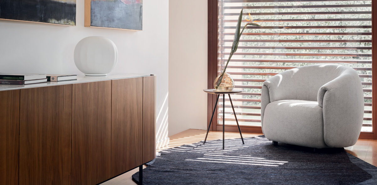 A close-up of the Calligaris Haven table's base, highlighting the intricate details of its metal construction and the interplay of its embracing elements.