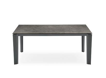 DELTA extendable table by Calligaris featuring a sleek ceramic top and slant-cut metal legs for modern interiors.