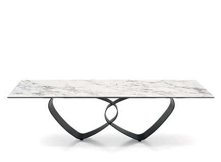 "BREEZE dining table by Calligaris with oval ceramic top and sculptural metal base in matte black finish."