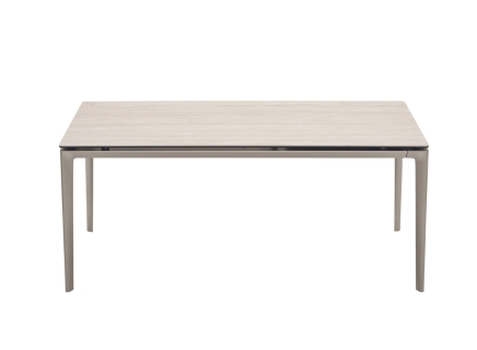 "Sleek Calligaris dining table with a rectangular ceramic top and slim metal legs in a bright room."