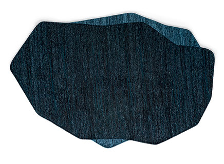 A contemporary Calligaris ROCHE rug, featuring an organic, irregular shape inspired by natural rocks and stones, with painterly contours and two distinct color nuances that add depth.