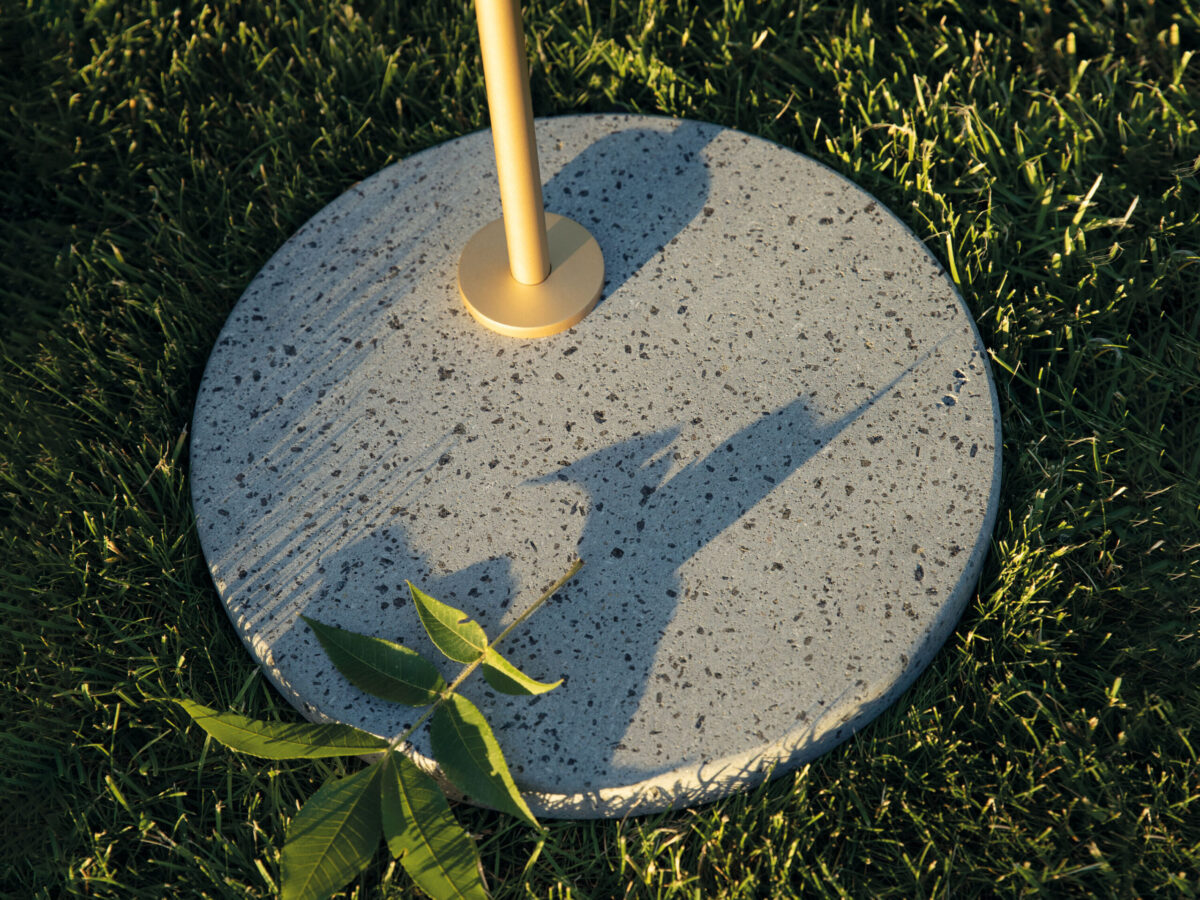 Tall Flos Captain Flint Outdoor lamp in 1537 mm height, combining brass finish with a textured stone base.