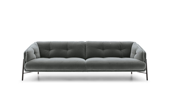 Modern Charm sofa by Nicoline in soft fabric upholstery with sleek metal legs.