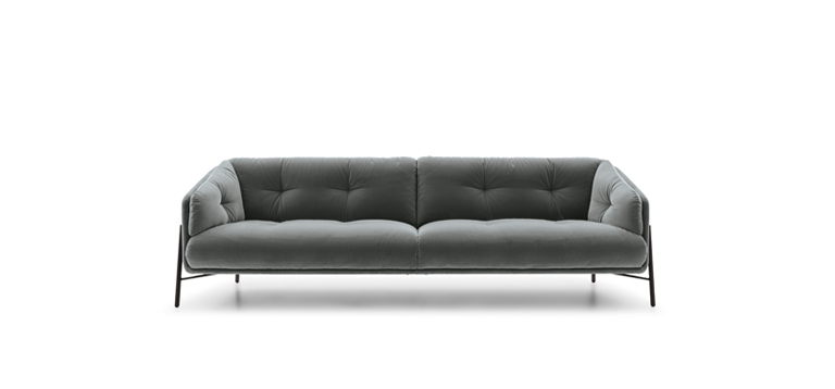 Modern Charm sofa by Nicoline in soft fabric upholstery with sleek metal legs.