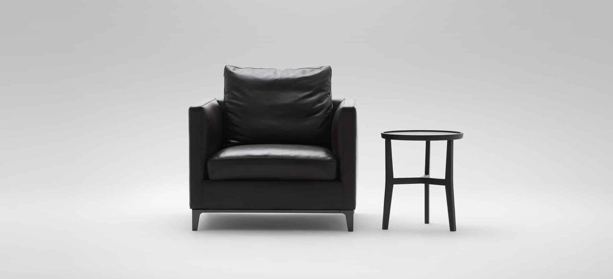 Crescent lounge chair featuring sculptural crescent-shaped back and smooth fabric seat