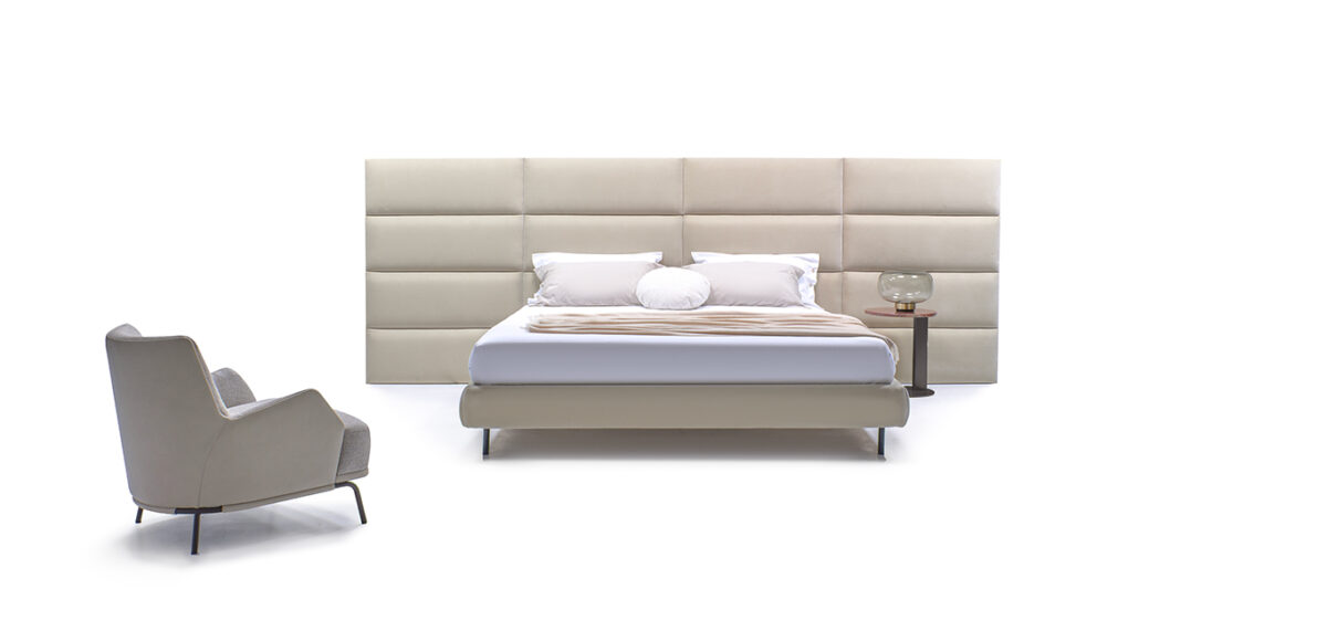 Dalia bed by Nicoline featuring a high upholstered headboard with individual panels in soft fabric, offering a luxurious and timeless design. Available at Italcasa Design, Royal Oak, Michigan.