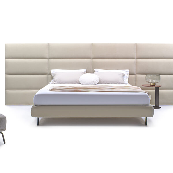 Dalia bed by Nicoline featuring a high upholstered headboard with individual panels in soft fabric, offering a luxurious and timeless design. Available at Italcasa Design, Royal Oak, Michigan.