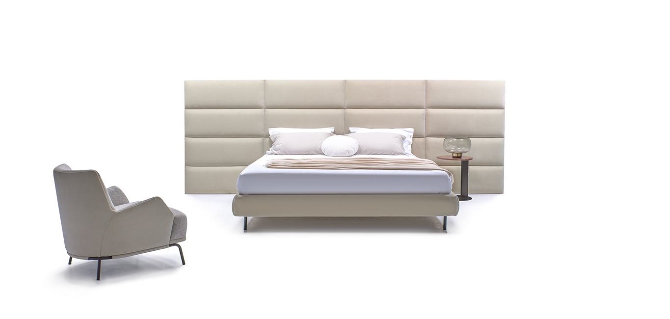 Dalia bed by Nicoline featuring a high upholstered headboard with individual panels in soft fabric, offering a luxurious and timeless design. Available at Italcasa Design, Royal Oak, Michigan.