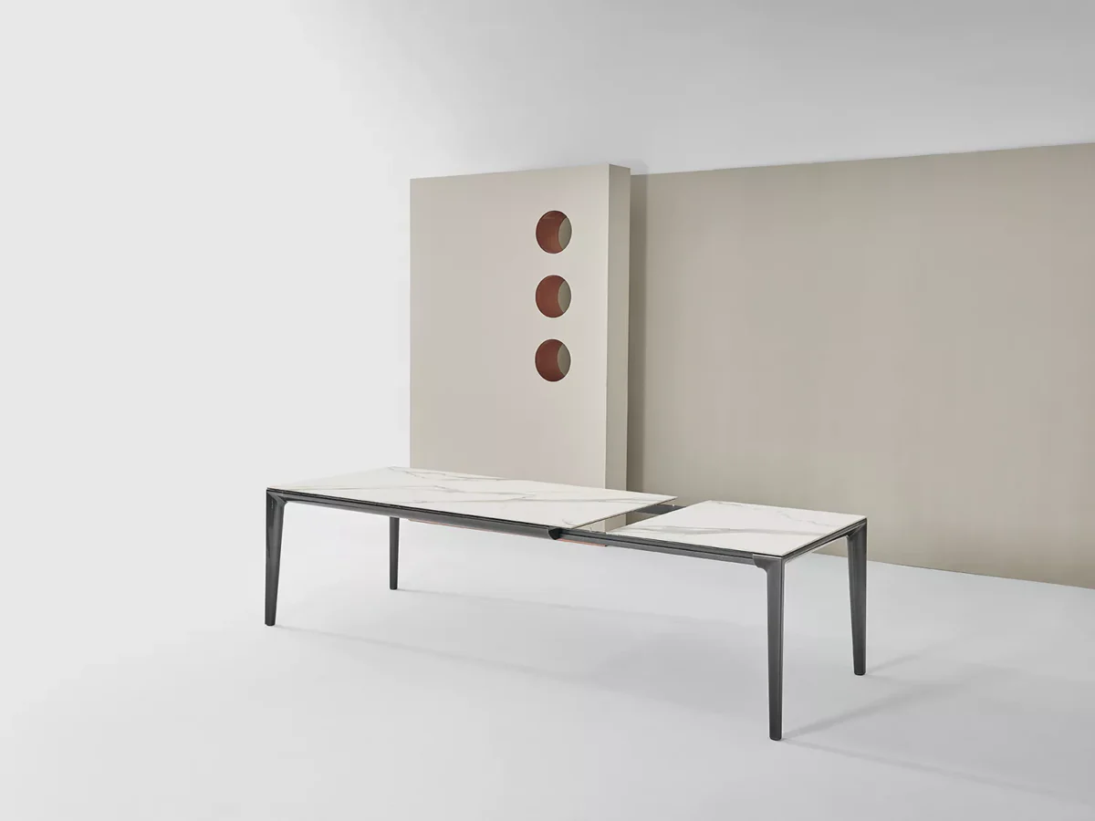 Duke by Bontempi placed beside a designer round dining table in a luxury open-plan kitchen.