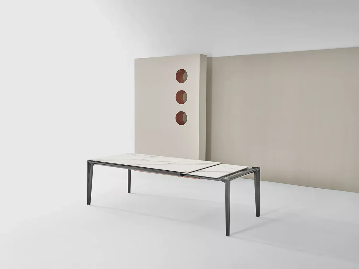 Duke by Bontempi placed beside a designer round dining table in a luxury open-plan kitchen.