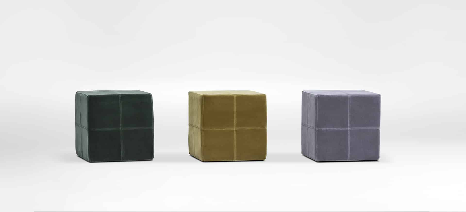 Dice Ottoman by Camerich in dark green velvet cube with cross‑stitch detail