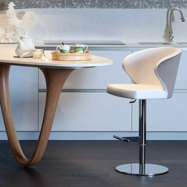 Doris P dining chair by Peressini featuring a sculpted plywood shell, high-density foam cushioning, and tapered metal legs in matte black.
