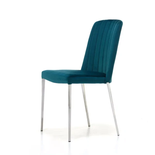 Dream 3 chair in teal velvet with tall, vertically quilted backrest and slim tapered metal legs, set against a white studio background.