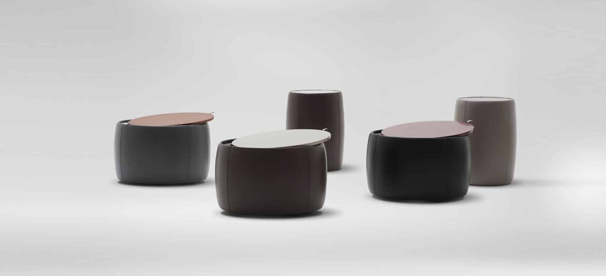 Round upholstered ottoman with soft fabric and minimalist design by Camerich.
