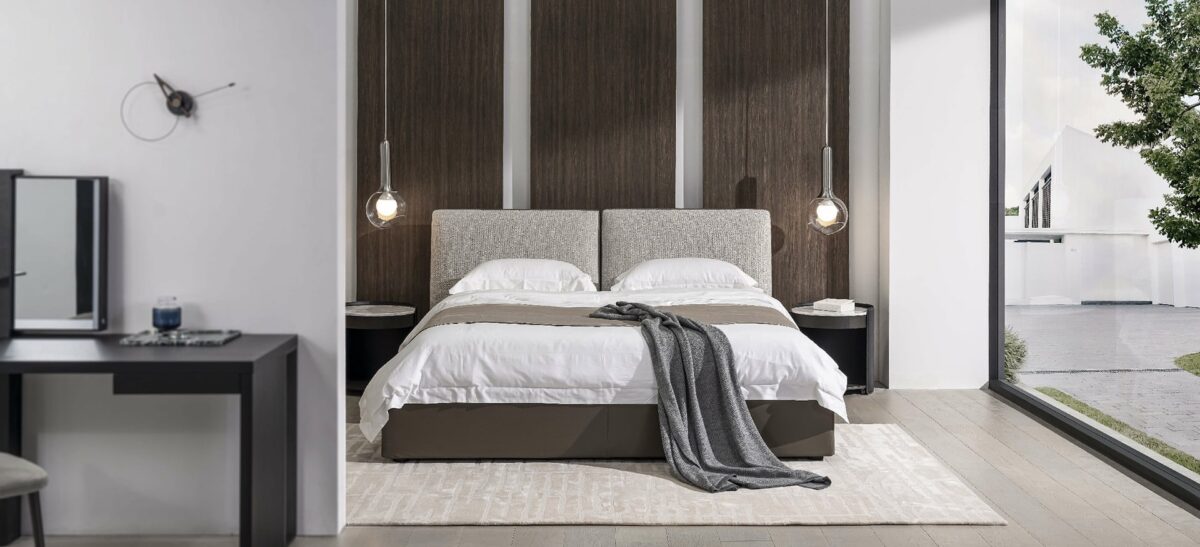 Minimalist upholstered bed with clean lines and low profile by Camerichusa.
