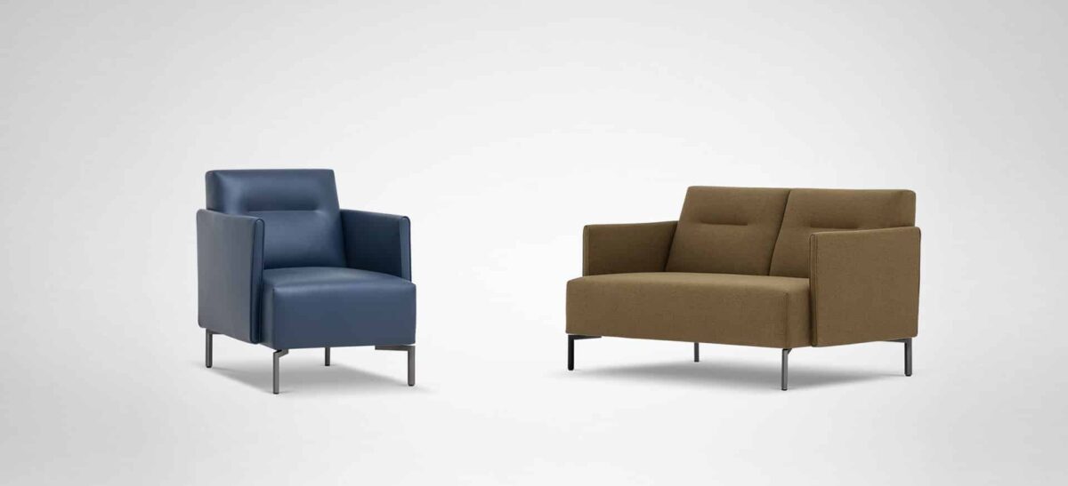 Cozy modern chair in muted green-grey fabric with padded armrests and anthracite metal legs