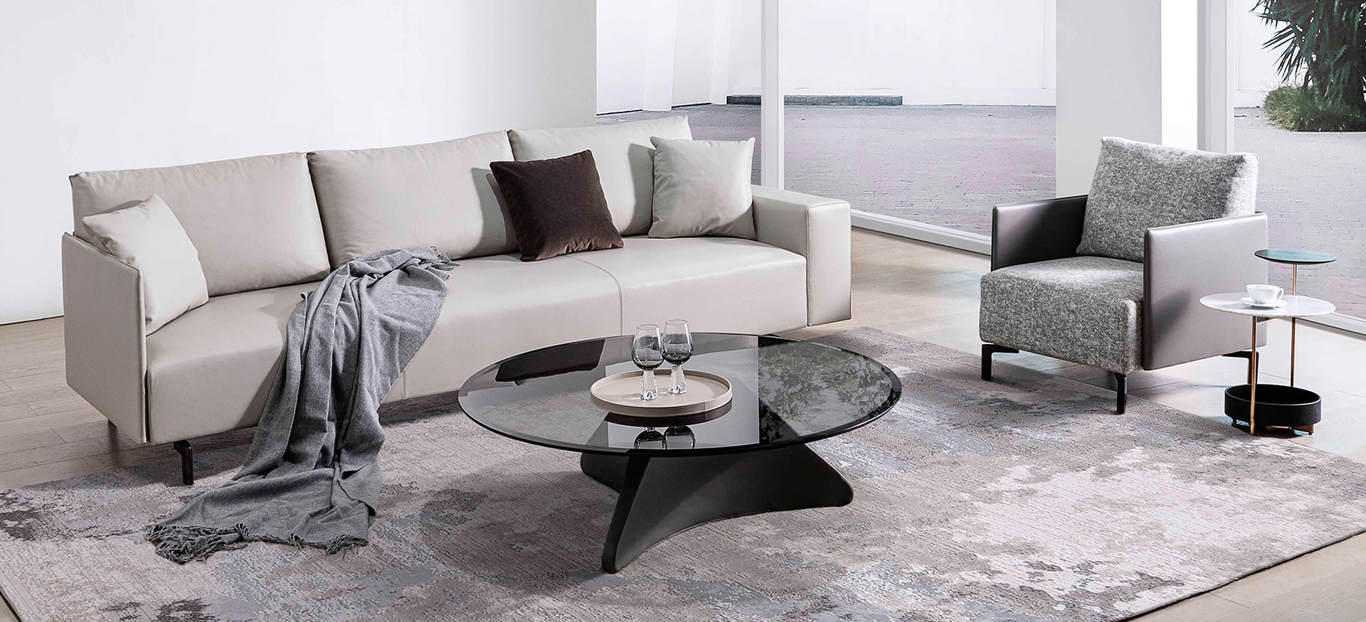 East‑West armchair by Camerich in soft beige leather with slim black metal legs
